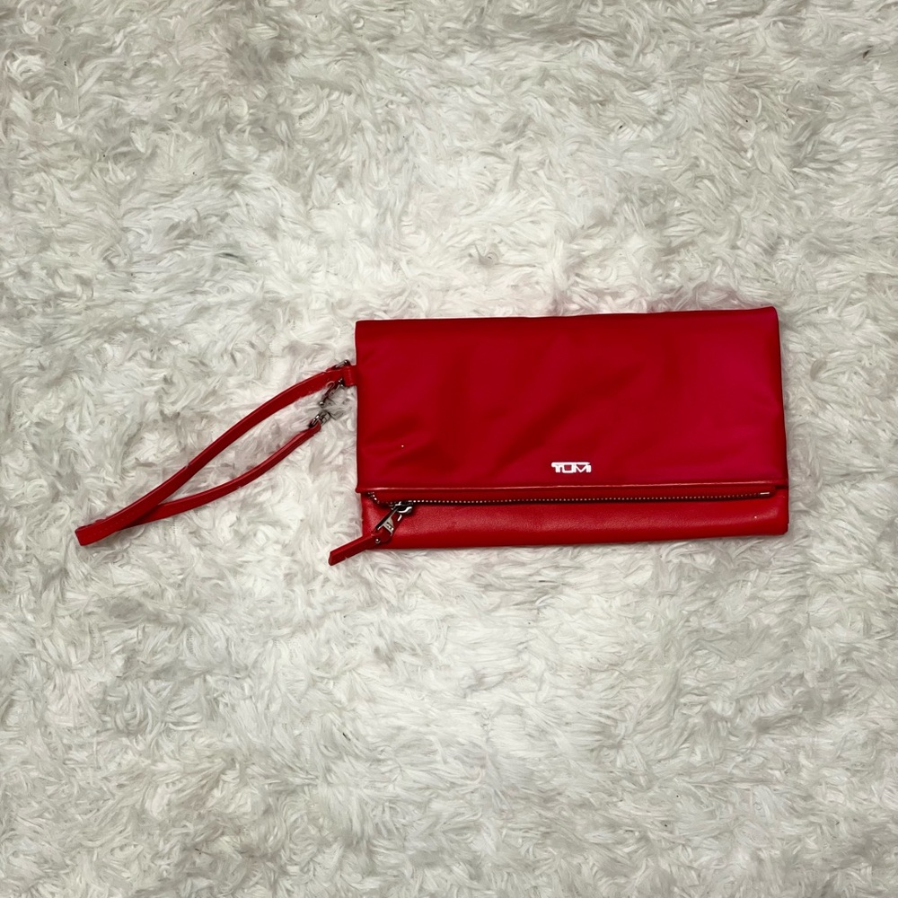 Red Tumi flap-front wallet wristlet
